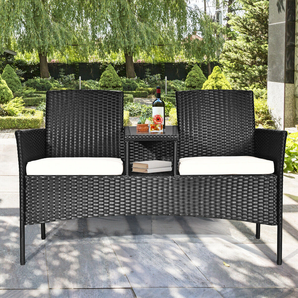Wicker patio conversation set featuring a durable steel frame, removable cushions, and a tempered glass table for.