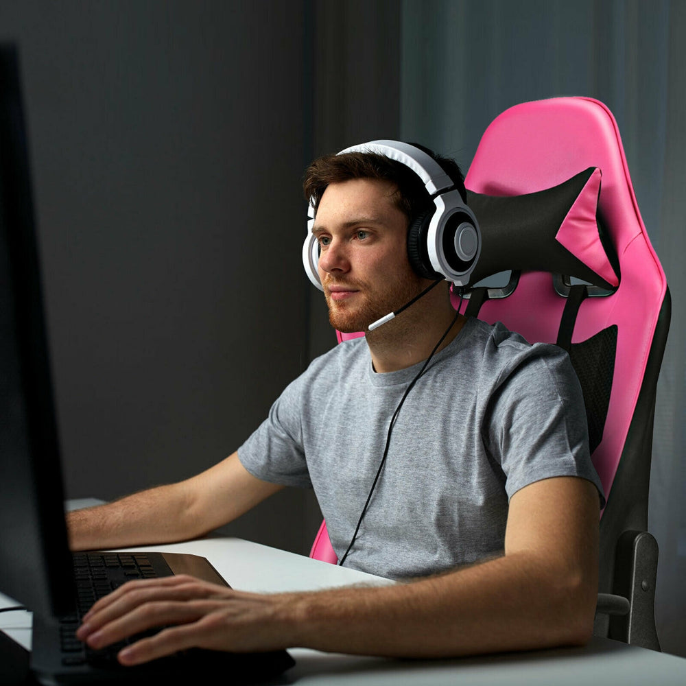 Gaming chair in pink with USB massage lumbar pillow, adjustable armrests, and retractable footrest for ultimate comfort.