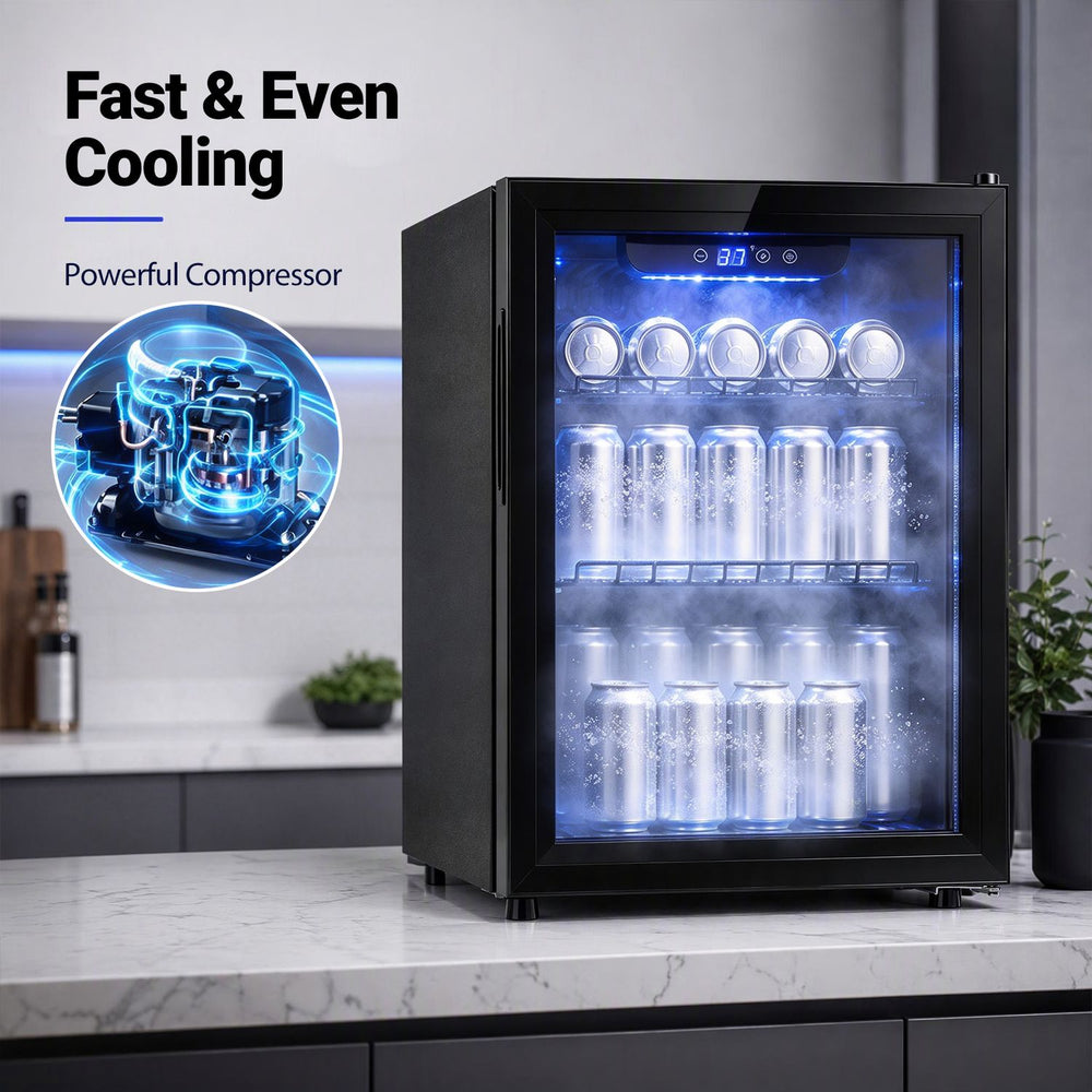 Black beverage refrigerator with glass door and LED lights displays cans and bottles in a kitchen setting.