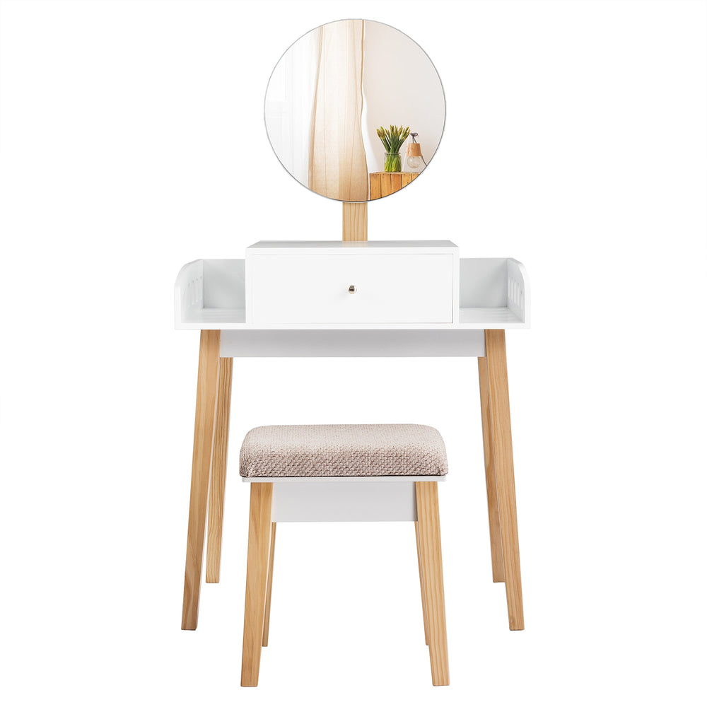 Wooden makeup dressing table set with round mirror, drawer, and cushioned stool, perfect for organizing makeup items.