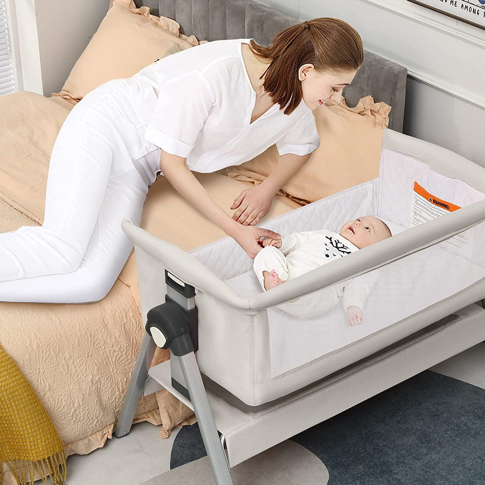 Portable baby bedside sleeper with removable fabric design and a large capacity basket for easy cleaning and comfort.