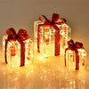 Three lighted gift box decorations with red ribbons, featuring 60 LED lights for festive indoor and outdoor displays.