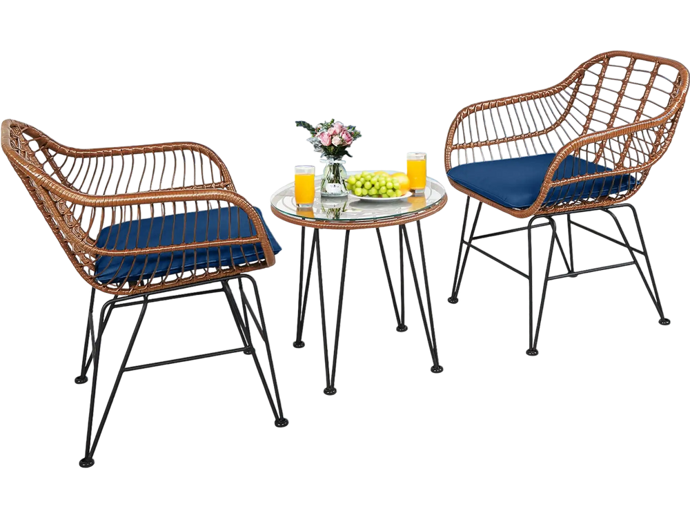 Two navy cushioned rattan armchairs and a glass-top side table on a patio by the pool, perfect for outdoor relaxation.