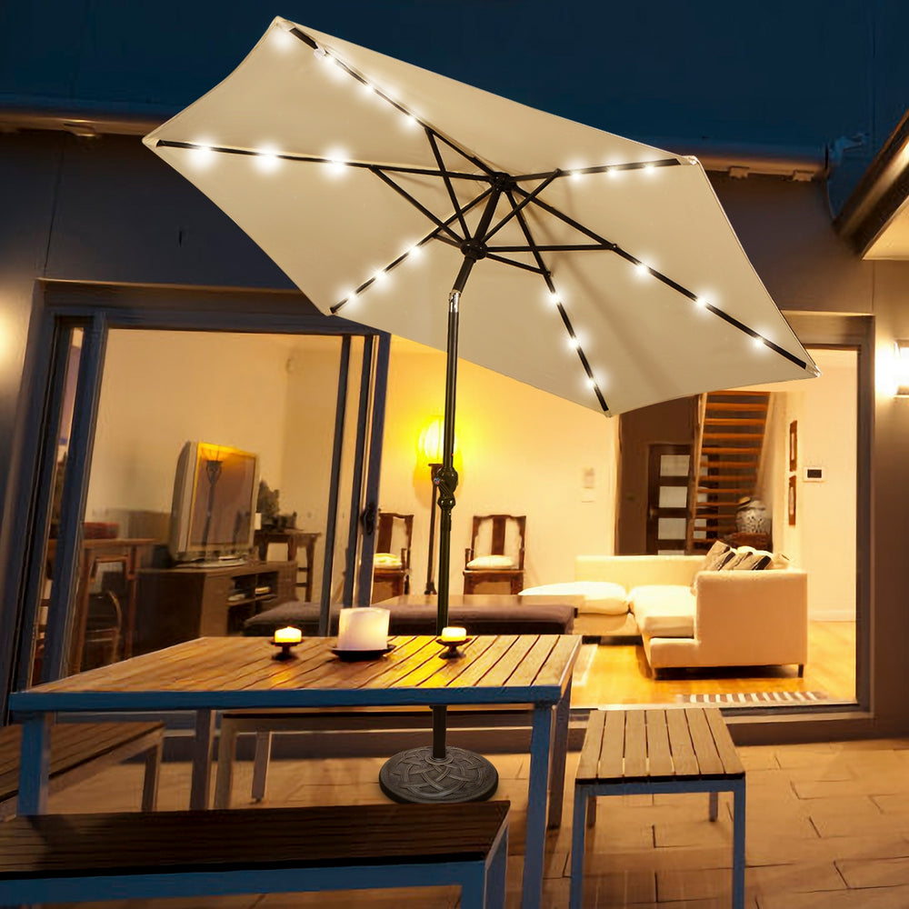Heavy duty round umbrella base stand with bronze finish, securely holding an umbrella for outdoor dining.