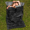 Two-person waterproof sleeping bag in black with two pillows, ideal for camping and outdoor use.