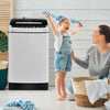 Child joyfully plays beside the full-automatic gray washing machine, showcasing its 1.5 Cu.Ft capacity and modern.
