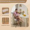 Beige upholstered bar stool with curved backrest and integrated footrest, perfect for kitchen islands and dining rooms.