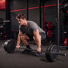 Weight lifting with a 7FT Olympic barbell featuring deep knurling and 2000 lbs capacity for home gym workouts.