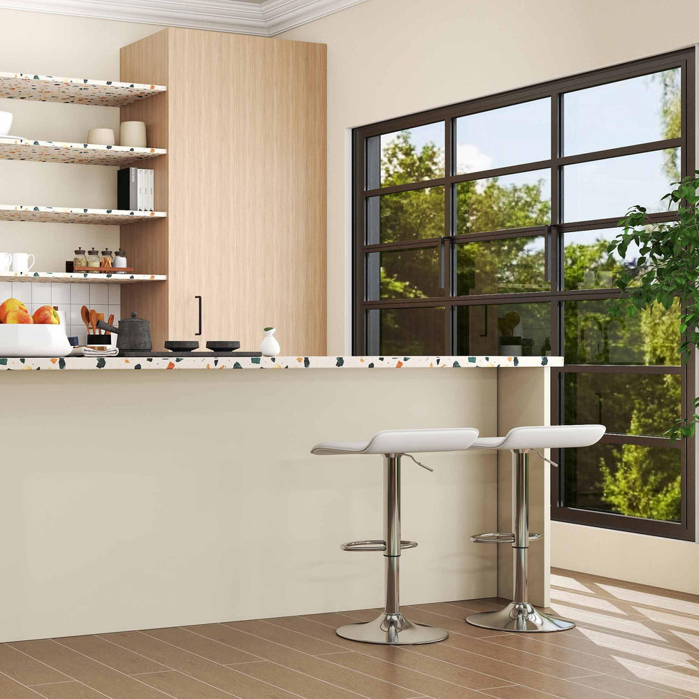 Adjustable white PU leather bar stools with 360° swivel beside a glass dining table in a modern kitchen setting.