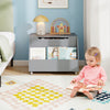 Gray wooden mobile toy storage organizer with lockable wheels, featuring a front bookshelf for easy access to books and.