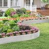 Galvanized metal landscape edging in a garden, creating custom shapes and borders for a neat flower bed.