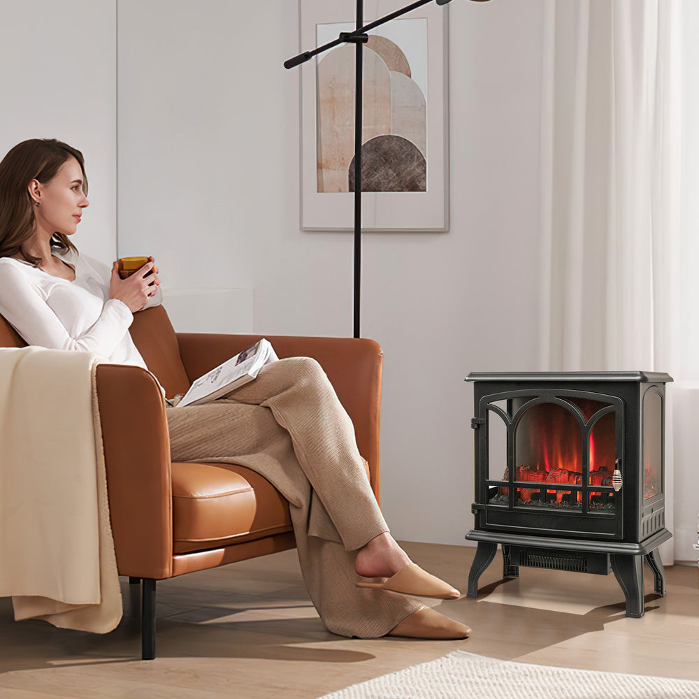 1400W electric stove heater in black with 3-level flame effect, placed in a cozy living room setting for warmth.
