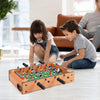Children playing with a 20-inch indoor competition soccer table featuring strong wood construction and solid steel rods.
