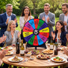 Multicolor 20-inch spin wheel with 14 slots, used for party games and events, shown in an outdoor gathering.