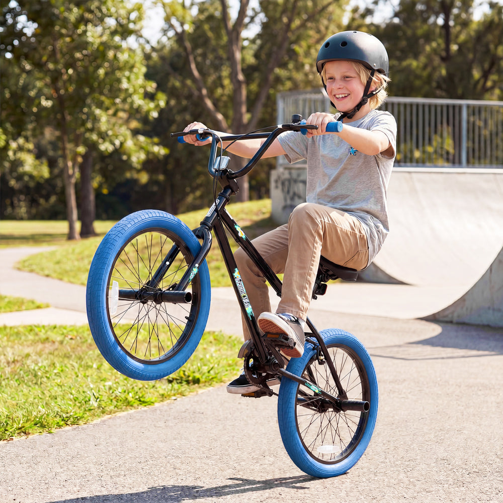 20" trick bicycle in navy with 360° steering, adjustable seat, and puncture-proof tires for kids and teens.
