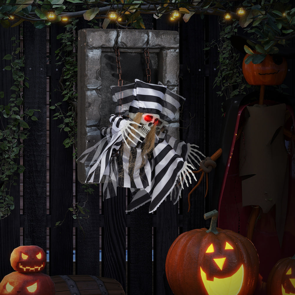 Hanging 18-inch animated skull prisoner decoration with LED eyes, sound effects, and realistic chained design for.
