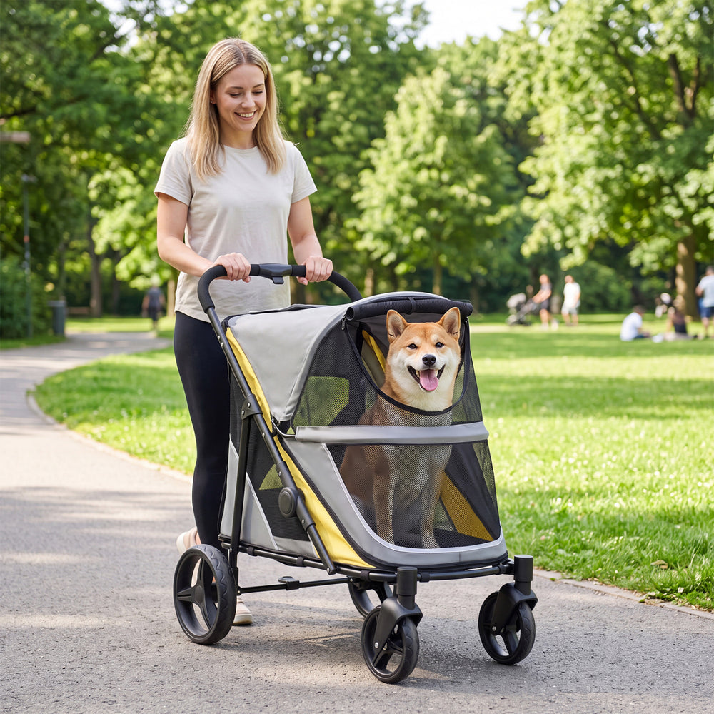 Heavy-duty dog stroller in yellow with spacious cabin, mesh walls, and big wheels for comfortable outdoor adventures.