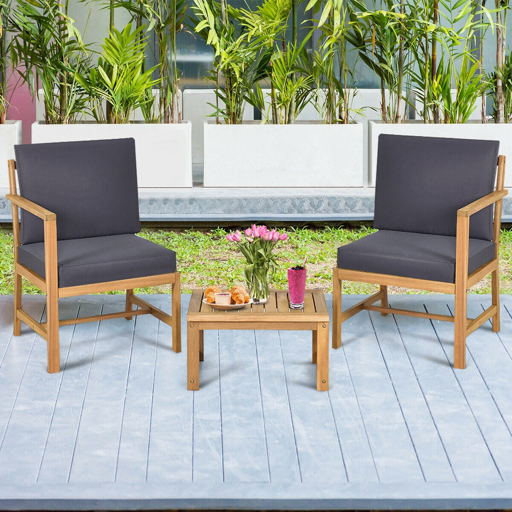 Two acacia wood chairs with thick cushions and a coffee table, perfect for outdoor relaxation in your backyard or patio.