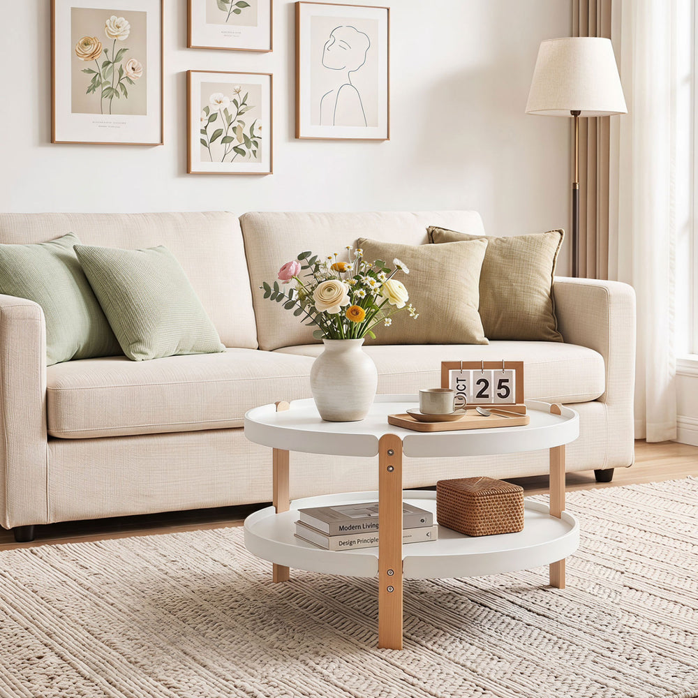 Round 2-tier coffee table with solid wood legs and open storage shelf, perfect for organizing living room essentials.