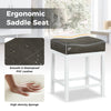 Black and white saddle stool with cushioned seat, made of PVC leather and high-density sponge, ideal for bar counters.