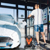 Electric pressure washer with 4 wheels in use, cleaning a car, featuring 2400 PSI and multiple nozzles for versatile.