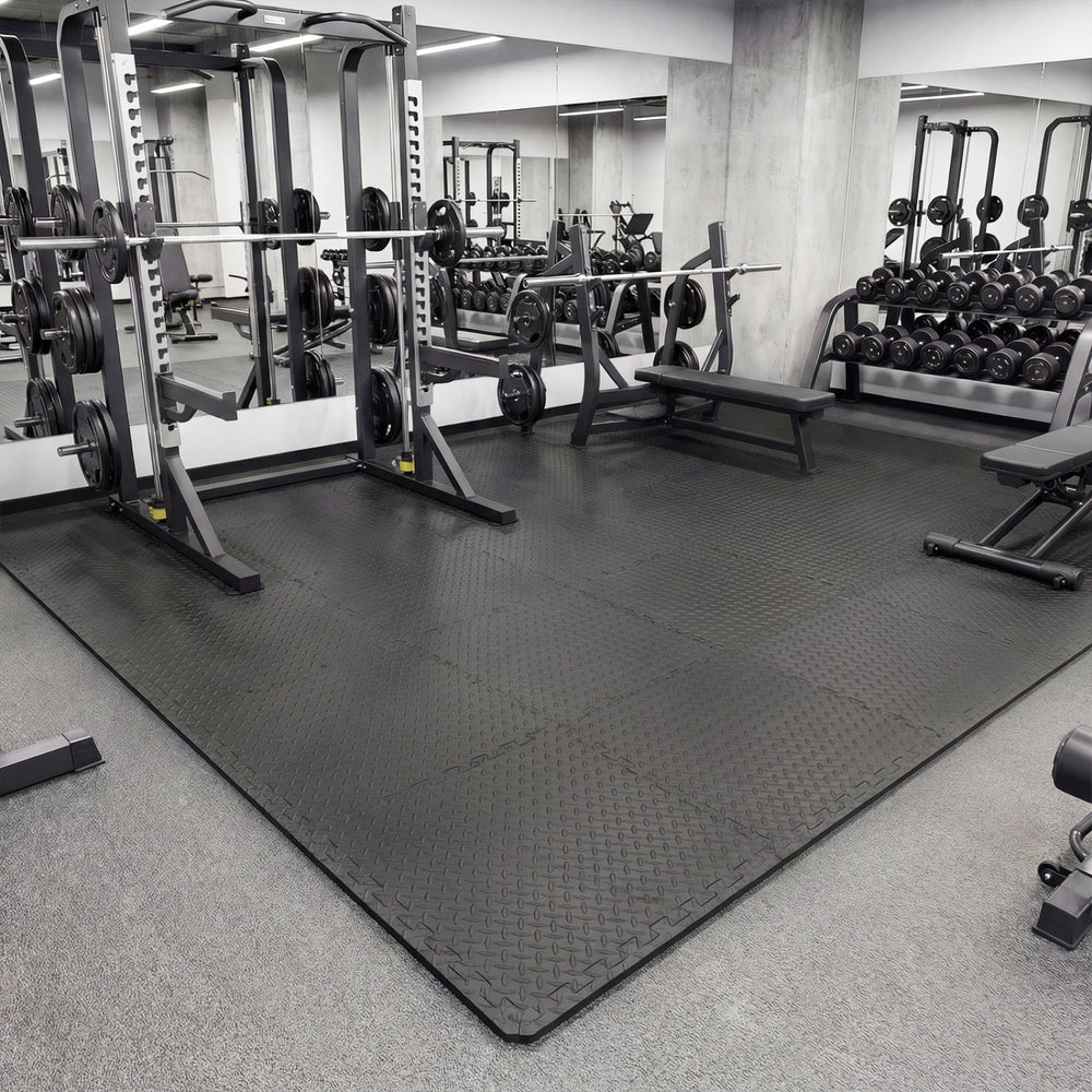 Black 1/2" puzzle exercise floor mats with non-slip texture, ideal for gyms and playrooms, providing impact cushioning.