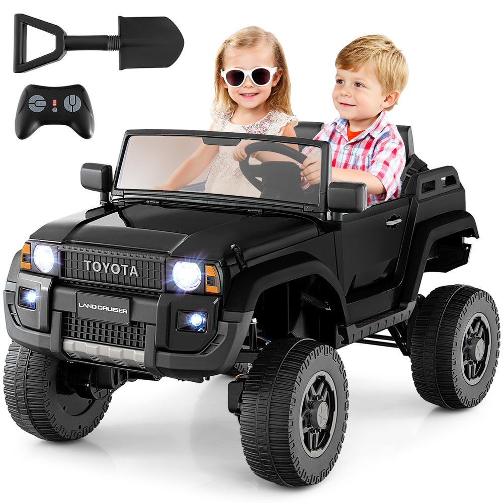 Kids enjoying the black 24V 2-seater ride-on car with remote control, featuring 4WD/2WD switchable for versatile.
