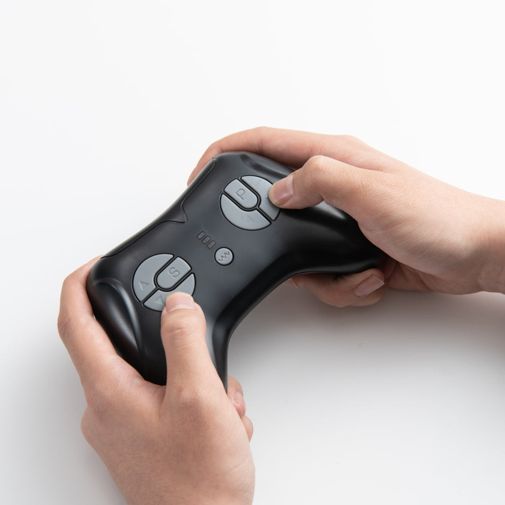Hands gripping the controller of a 24V kids ride-on dump truck, featuring realistic truck controls for interactive play.