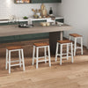 Set of 4 24.5-inch saddle stools with walnut acacia wood seats and gray legs, perfect for kitchen islands and dining areas.