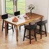 Wooden bar table set with 24.5-inch swivel black stools, featuring rubber wood legs and low backs for dining or casual.