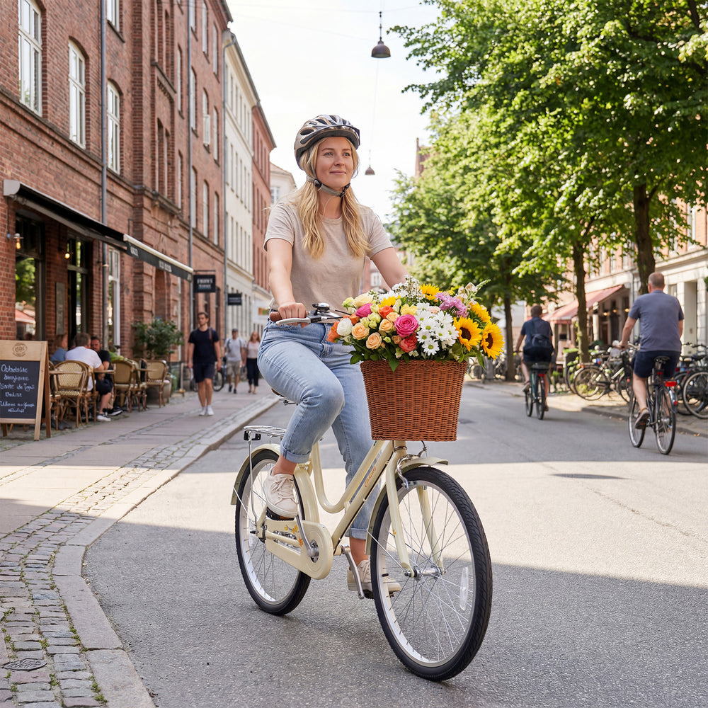 Woman riding a 24-inch beige beach cruiser bike with a woven basket, perfect for urban commuting and floral decoration.