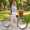 24-inch pink beach cruiser bike with woven basket, cup holder, and adjustable seat for comfortable riding in the park.