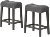 Set of 2 gray saddle bar stools with padded seats, button-tufted design, and solid rubber wood frame for kitchen.