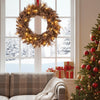 24-inch pre-lit Christmas wreath with 105 branch tips and 35 warm white LED lights, perfect for festive wall or window.