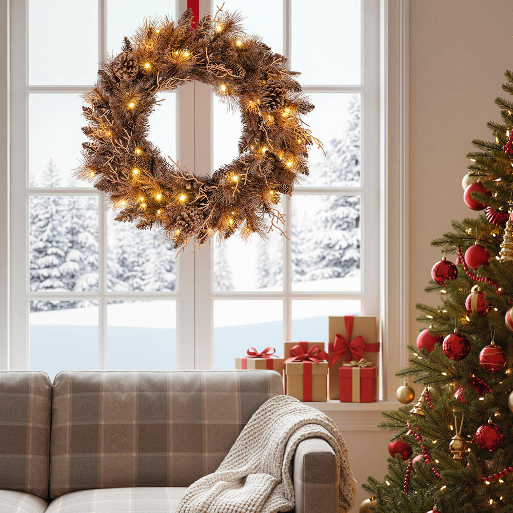 24-inch pre-lit Christmas wreath with 105 branch tips and 35 warm white LED lights, perfect for festive wall or window.