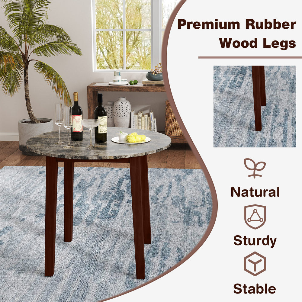 Round dining table with marble-textured veneer and sturdy rubber wood legs, ideal for dining and workspace use.