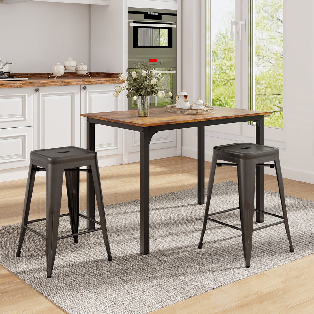 Set of two 24-inch Tolix style counter height barstools in gunmetal, stackable design for kitchen or home bar use.