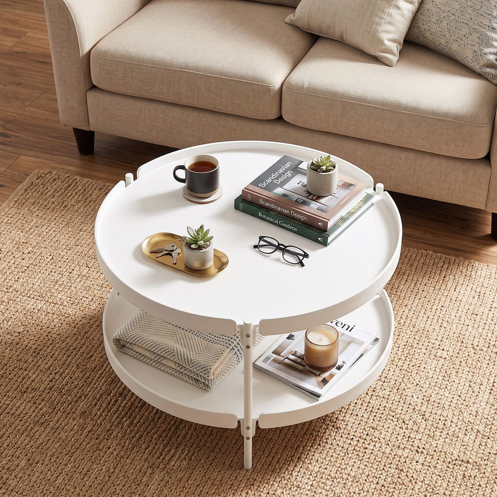 Round 24" white coffee table with plastic top and metal legs, featuring an open shelf for extra storage in small spaces.