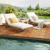Acacia wood interlocking deck tiles in a natural finish, arranged on a patio by the pool for outdoor use.