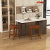 Set of 2 upholstered PU leather bar stools with saddle seat, featuring sturdy rubber wood legs for kitchen or dining.