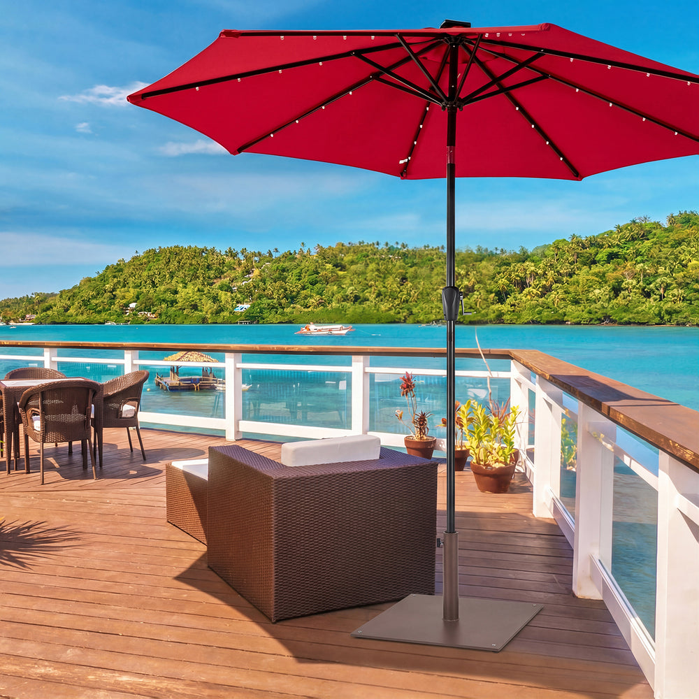Brown 25-inch square patio umbrella base with adjustable knob, designed for stability on uneven ground in outdoor.