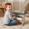 Kids playing with a 25 keys wooden piano toy in green, designed for safe and creative music learning.