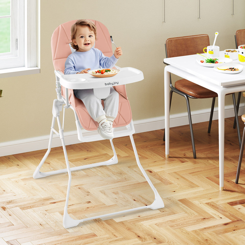 Pink Easy Clean Compact Highchair with a child seated, featuring an adjustable tray and safety harness for secure.