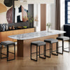 Gray bar stools with faux leather seats and metal frames, perfect for kitchen islands or home bars, shown in a modern.