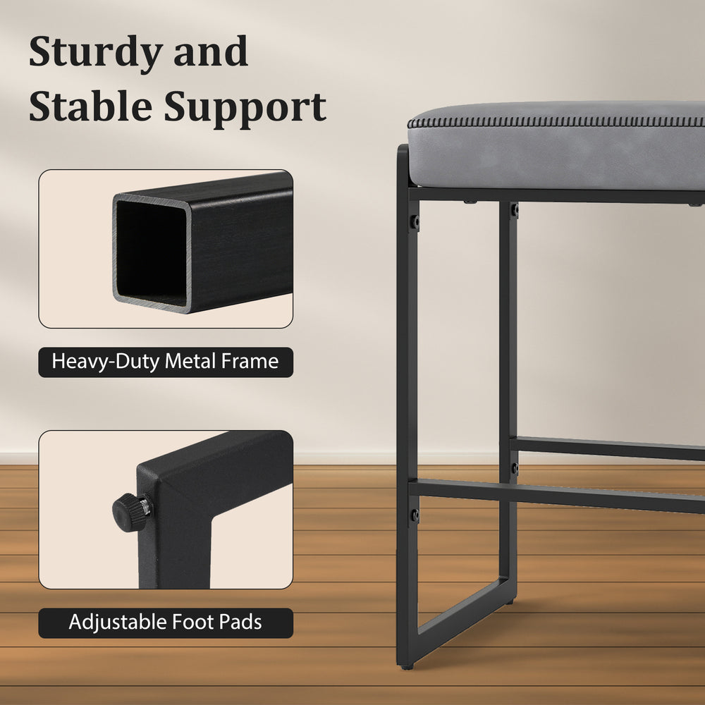Gray faux leather upholstered bar stool with heavy-duty metal frame and adjustable foot pads for kitchen counter height.