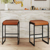 Set of two 26-inch bar stools with brown faux leather seats and sturdy metal frames, perfect for kitchen counters.