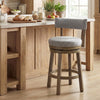 Swivel bar stool with upholstered back and footrest, featuring solid rubber wood legs and a 5" thick cushion for.