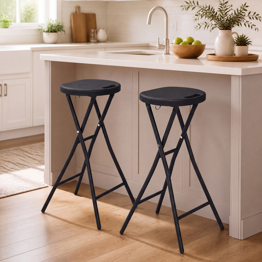 Two black folding bar stools with HDPE seats and carry handles, perfect for kitchen bars and easy transportation.