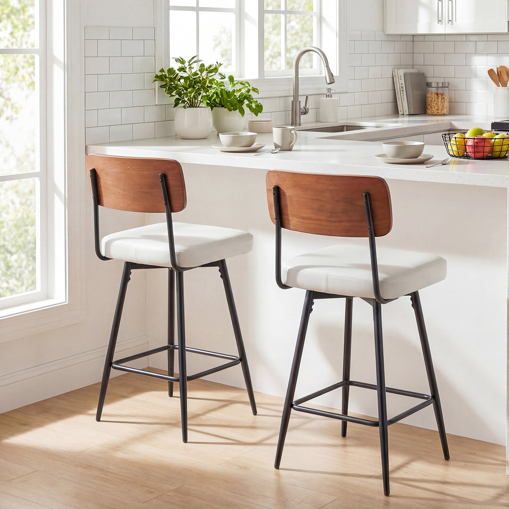 Set of 2 white padded counter barstools with metal legs and curved wooden backrests, perfect for kitchen or dining use.