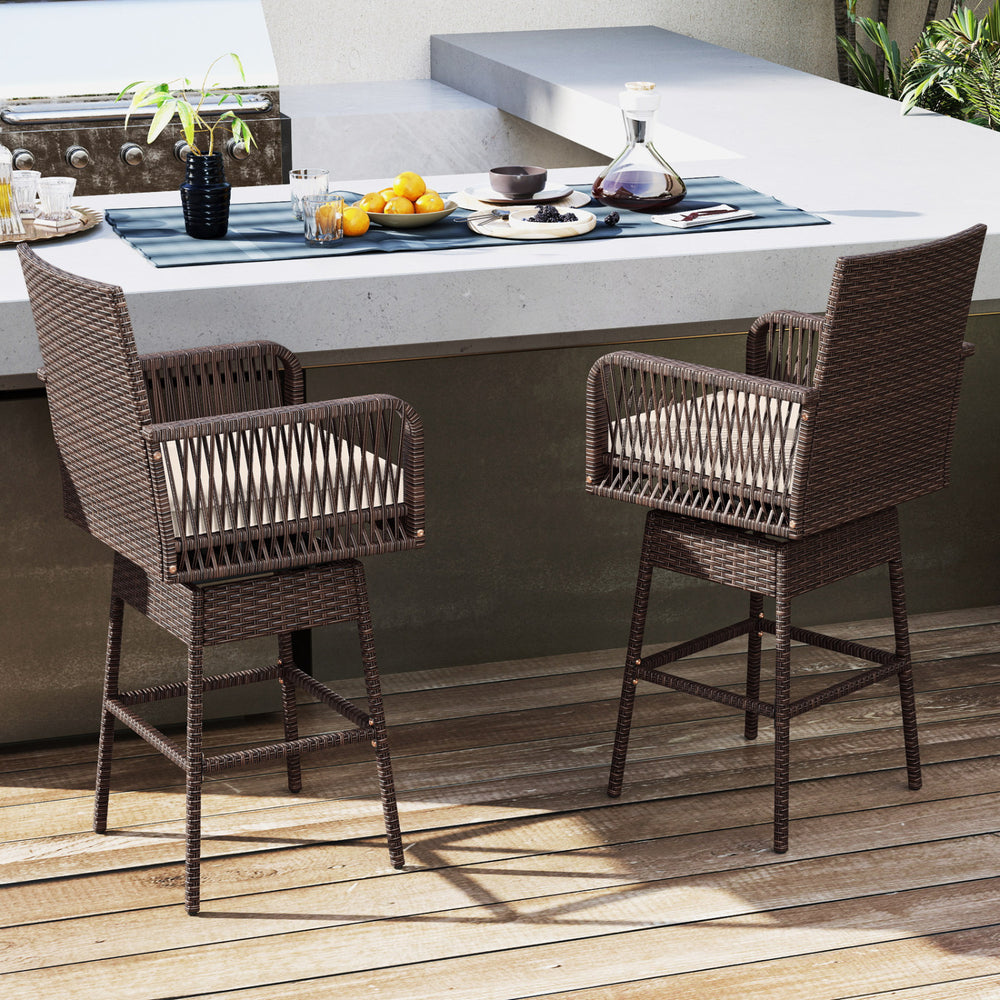 Bar height patio swivel bar stools in brown PE rattan with cushioned seats, ideal for backyard or poolside use.